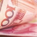 Holding a stack of chinese mone